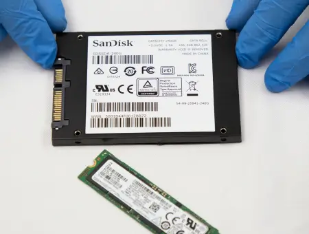 A data recovery engineer working on two different types of SSDs.